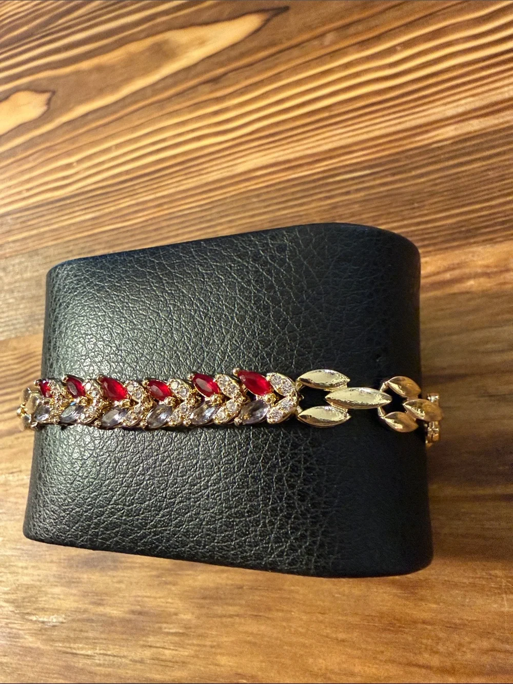 Gold-Tone Bracelet with Red Gem Leaf Accents